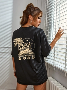 Oversized black cotton T-shirt featuring vintage Life's A Beach back graphic and palm trees