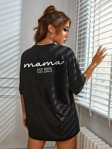 Women's oversized black cotton T-shirt featuring mama EST. 2023 print on the back