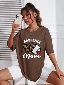 Close-up of brown oversized t-shirt with Baseball Mom print and leopard heart detail