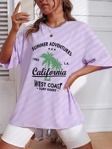 Close-up of light purple oversized T-shirt with vintage California palm tree graphic