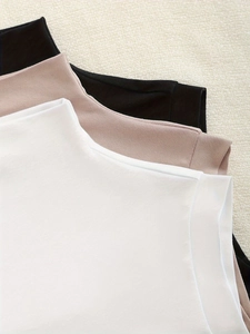 Slim fit sleeveless turtleneck tops in white, pink, and black ribbed knit fabric