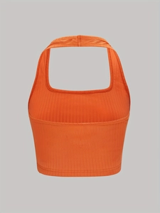 Detailed view of the orange ribbed knit fabric and halter neckline on a cropped tank top