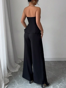Chic black two-piece set featuring a peplum tube top and high-waisted wide-leg trousers
