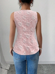 Pink sleeveless top with floral jacquard texture shown from back on a model