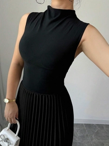 Detail view of the elegant black high neck sleeveless knitted top with pleated skirt fabric