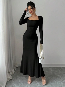 Detail of square neckline and ruched waist on a slim black long-sleeve fishtail dress