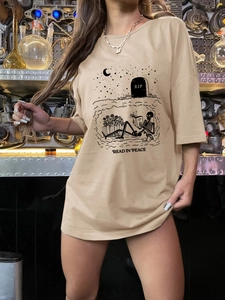 Detailed view of khaki oversized T-shirt with Read In Peace skull graphic print