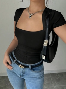 Slim fit black square neck knit top with blue jeans and designer belt for women
