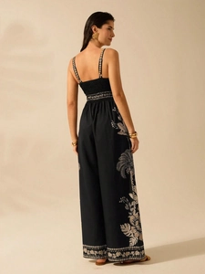Elegant black V-neck sleeveless jumpsuit with tropical palm print and smocked back