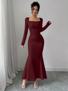 Detail of burgundy square neck dress with pleated waist and elegant fishtail hemline