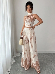 Chic two-piece summer set with halter crop top and printed wide-leg pants in ivory and brown
