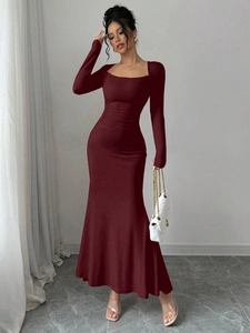 Close-up of elegant square neck and ruched waist detail on burgundy fishtail dress