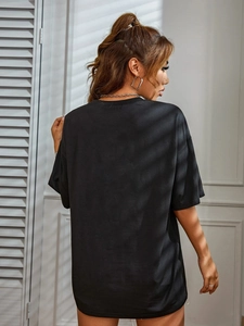 Back view of a black oversized short sleeve T-shirt with stylish window shadow patterns