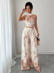 Detail of tropical palm print fabric on halter crop top and wide-leg trousers
