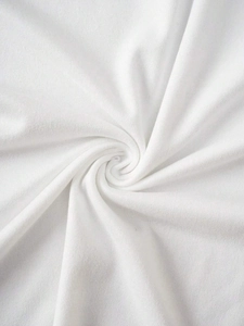 Detailed macro view of white premium cotton fabric texture with soft spiral folds