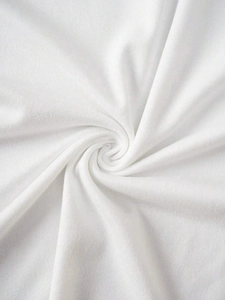 Close-up of white cotton fabric texture showing soft knitting and smooth drape detail