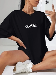 Oversized black crewneck T-shirt with white Classic print on model in casual setting