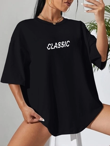 Detail of classic black oversized cotton T-shirt featuring creative split lettering print