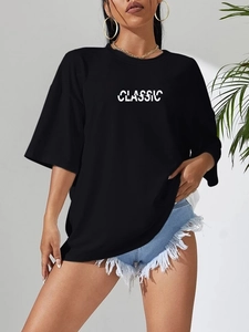 Detail of classic white typography on a black oversized minimalist cotton t-shirt