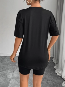 Women's casual black oversized round neck t-shirt and biker shorts set back view
