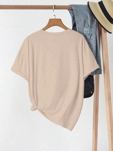 Detail view of apricot casual T-shirt featuring a stylish side knot and rolled cuffs