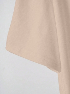 Detail of soft beige cotton T-shirt sleeve with high-quality double-needle stitching