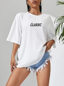 Detail of white oversized T-shirt with black CLASSIC print and drop shoulder design