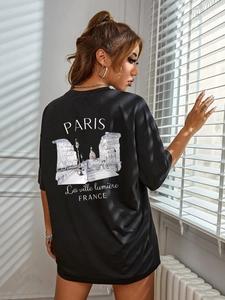 Close-up of black oversized T-shirt back featuring artistic Paris building sketch print
