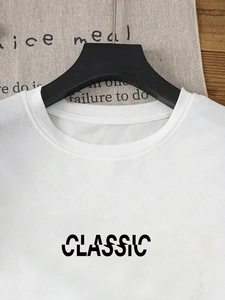 Close-up of white round neck T-shirt with black artistic CLASSIC print detail