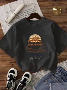 Casual dark grey crew neck T-shirt with vintage palm tree graphic on wooden background