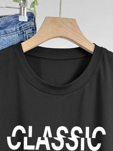 Women's black cotton t-shirt with classic letter print on a wooden hanger