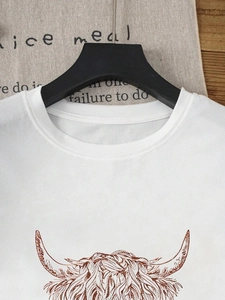 Detail of white cotton T-shirt featuring a hand-drawn brown highland cow graphic