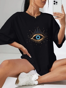 Women's black oversized cotton T-shirt featuring a gold and blue evil eye graphic print