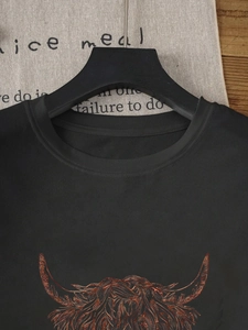 Women's black cotton t-shirt with metallic highland cow print and classic round neck