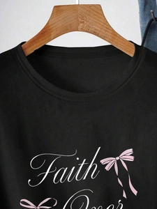 Women's black crewneck cotton T-shirt featuring 'Faith' text and pink ribbon bow prints