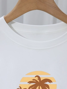 Detail of round neckline with double-needle stitching and sunset palm tree print