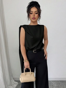 Elegant sleeveless black blouse with asymmetrical draped sash and wide-leg trousers
