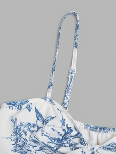 Close-up of blue Toile de Jouy print on white camisole with adjustable straps