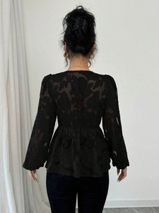 Elegant black semi-sheer floral burnout peplum top with long sleeves and V-neck back design