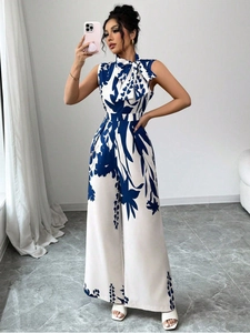 Detail view of the elegant bow neckline and blue floral pattern on wide-leg jumpsuit