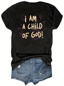 Detail of black cotton T-shirt with I AM A CHILD OF GOD graphic and distressed denim shorts