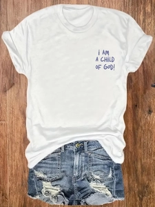 White cotton t-shirt with child of god print and distressed denim shorts flat lay