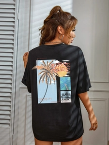 Women's black loose T-shirt with a colorful tropical palm tree back print and sunset design