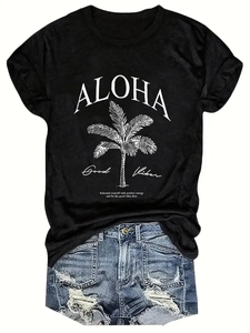 Flat lay of a black Aloha palm tree print T-shirt paired with ripped denim shorts