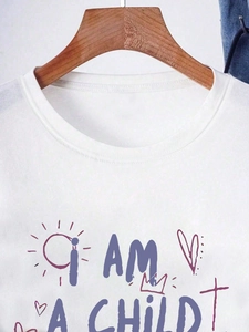 Detailed close-up of white crew neck cotton T-shirt with purple I AM A CHILD graffiti print