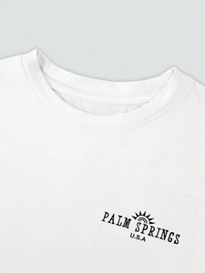 Close-up of crew neck detailing and Palm Springs print on white cotton t-shirt