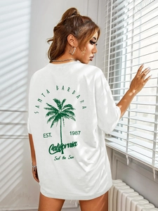 Detail of white oversized T-shirt with green palm tree back print and California text