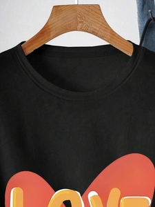 Close-up of black cotton T-shirt featuring a red heart and LOVE letter print on chest