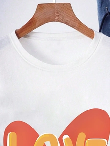 White crew neck T-shirt featuring a vibrant orange and yellow LOVE graphic print