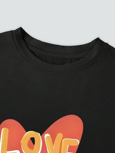 Close-up of crew neckline and colorful LOVE print on a black cotton casual t-shirt